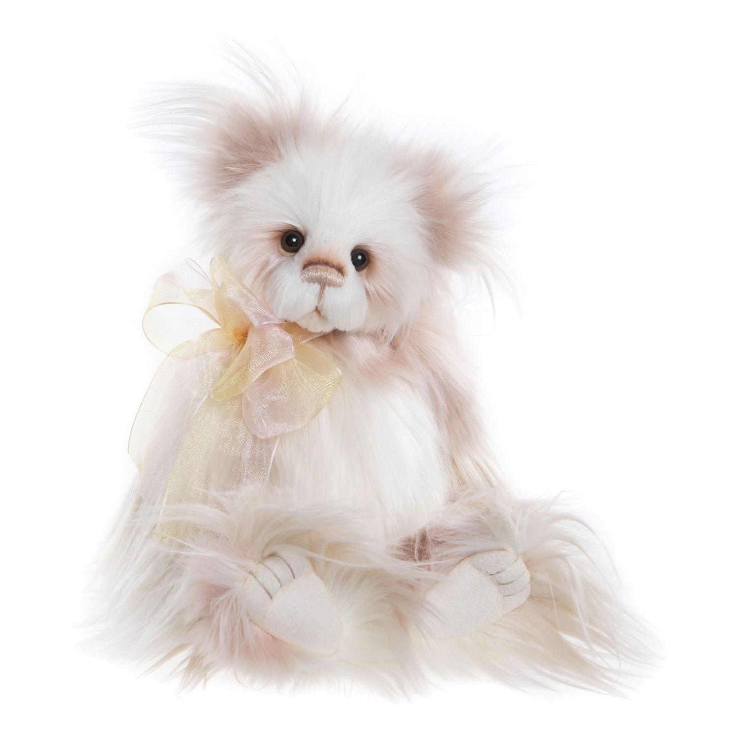 This is Kaleena by Charlie Bears. The plush has long, wispy, fluffy fur with a soft sheen and a slightly tousled, feathered texture. The coat is primarily white with noticeable beige and pink shading around the ears, cheeks and body. The muzzle and tummy are white with subtle beige shading; the inner ears show beige-pink tinting; the paws appear covered in the same white fur with pale beige suede-like paw pads. The eyes are dark brown or black glass/plastic with a glossy finish. The nose is pale brown ...